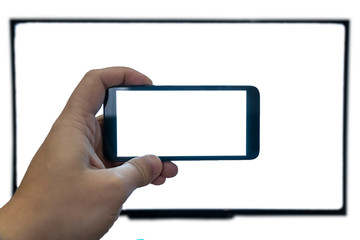 Seeing only through a screen concept. Man holding phone in front of a tv