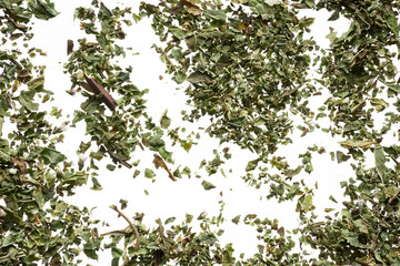A scattering of elite green tea on a white background
