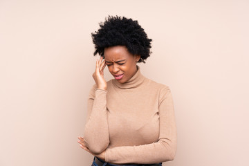African american woman over isolated background with headache