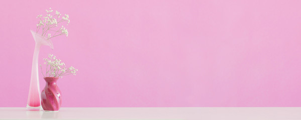  gypsophila flowers in vases on pink background