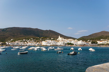 Fototapeta na wymiar Little boats close to a white mediterranean village in a summer day