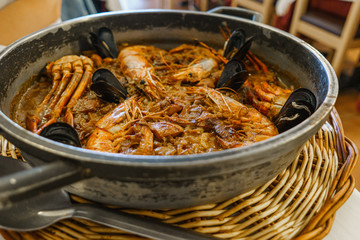 Rice with lobster, shrimps and mussels in a pan