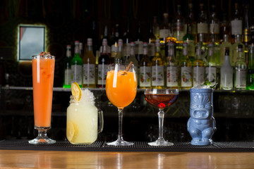 Variety of cocktail drinks on bar counter background