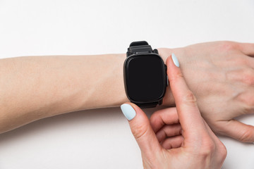 Fashion watch on a woman's wrist. Smart watch on white background. Copy space