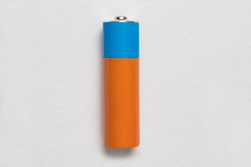 Generic alkaline battery on white background. Copy space