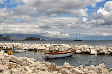 Fototapeta na wymiar small boat and landscape with castle in Naples photography