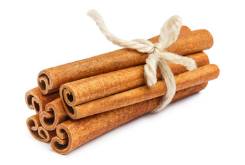 Delicious cinnamon sticks bunch tied with a rope, isolated on white background