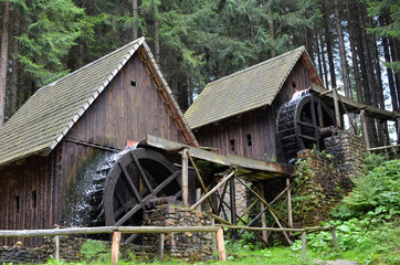 two old wooden water mill with mill-wheel detail photo - 321523796