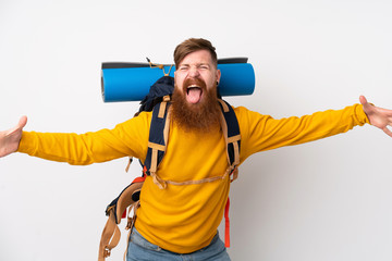 Young mountaineer man with a big backpack over isolated white background