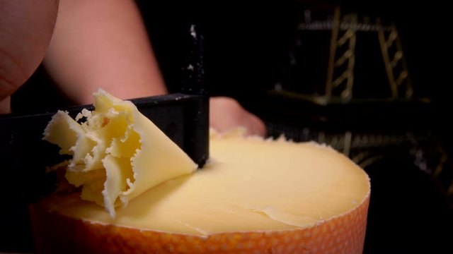 Girolle cheese scraper special knife cuts shavings from a top of hard parmezan cheese wheel