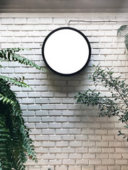 Blank signboard on the wall. Circle signage mockup. Store or cafe signboard. Mockup photo.