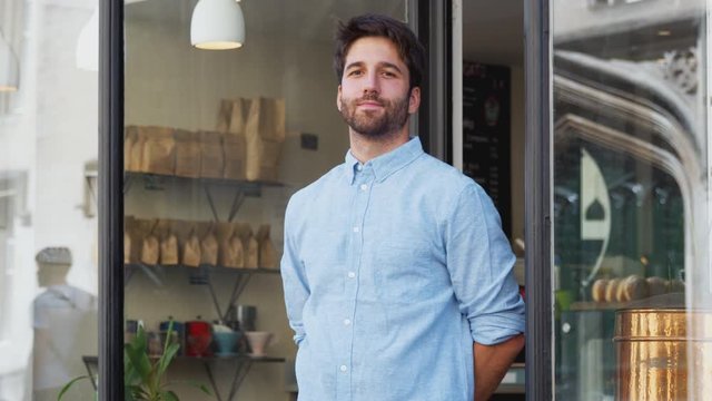 Portrait Of Male Owner Standing Outside Coffee Shop
