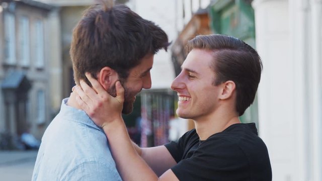Loving Male Gay Couple Kissing Outside In City Street