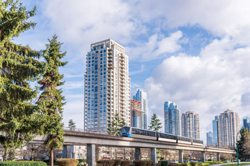 View over Cityscape and train on sunny day in Vancouver, Canada.