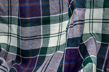 Green, blue, purple and white checkered and striped wool fabric texture