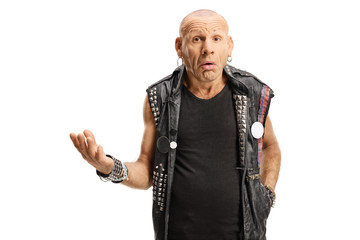 Middle aged bald punk making a grimace and gesturing with hand