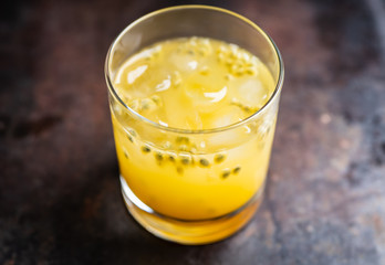 Old fahioned passion fruit cocktail on the rustic background. Selective focus. Shallow depth of...