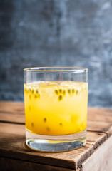Old fahioned passion fruit cocktail on the rustic background. Selective focus. Shallow depth of...