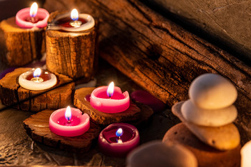  burning candles with ornate wood