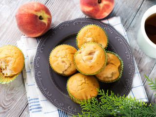 Vegan eggs free spelt wheat muffins with peaches and apples in green paper cases on checkered napkin