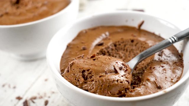 delicious chocolate mousse in bowl with spoon
