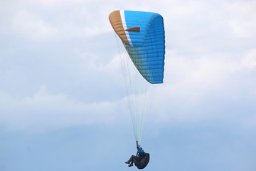 Paraglider flying wing in a blue sky	