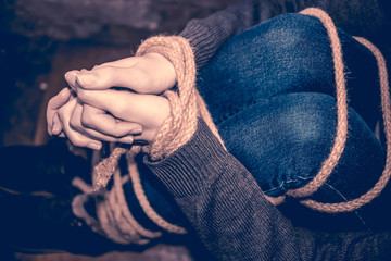 Bound feet and hands of the girl. Concept of kidnapping, violence