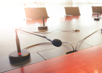 tabletop microphone on a wooden table in a boardroom