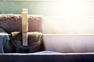 a white clothespin holds a dress hanging on a drying rack to dry