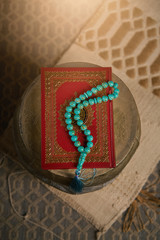Islamic holy book Quran with rosary beads, muslim faith Allah and prophet Muhammad holy spirit religion symbol concept