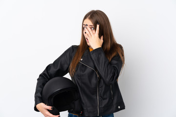 Obraz premium Woman with a motorcycle helmet covering eyes and looking through fingers