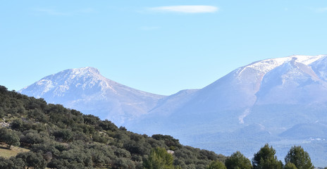 Andalusian landscape one winter morning with Mediterranean mountain and snowy peaks in the background