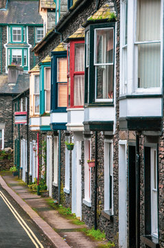 Colourful windows of small houses aligned in a street of Bowness on Windermere