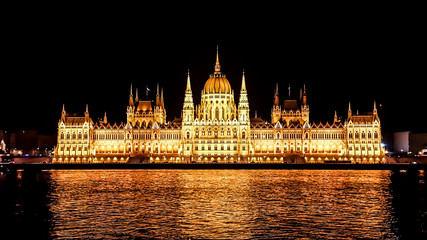 Fototapeta premium Budapest Parliament in Hungary at night. View form the Danube river.