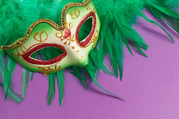 Festive, colorful masks of Mardi Gras or carnival mask on purple background. Venetian masks and...