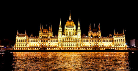 Budapest Parliament in Hungary at night. View form the Danube river.