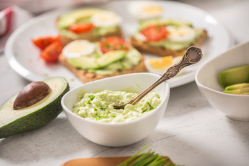Avocado spread guacamole toasts egg tomato chives as breakfast meal or appetizer