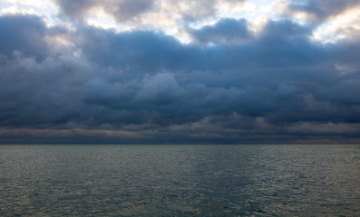 blue dark cumulus stormy clouds above the sea