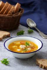 Dietary soup with meatballs, potatoes and noodles served with rye bread with bran. Children's menu.