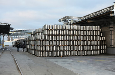 Beer metal barrels stacked in a warehouse