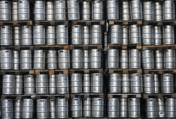 Beer metal barrels stacked in a warehouse