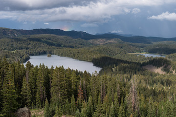 View Point on Grand Mesa National Forest Colorado has over 300 lakes. Partial Rainbow above Island Lake, which is one of the more popular destinations on the Grand Mesa.