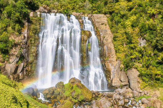 New Zealand, Oceania, North Island, Waikato Region, Marokopa River and Marokopa Falls with rainbow
