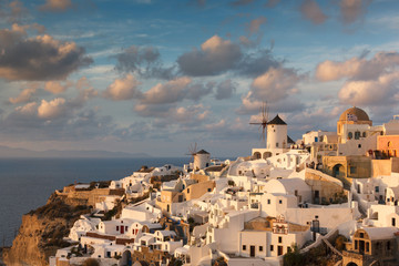 he city on Santorini in Greece is Oia, a place where the most beautiful sunsets are set against the backdrop of the Caldera, old houses and mills. The most popular sunset viewing point