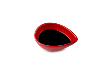 Soy sauce in red dish isolated on white background