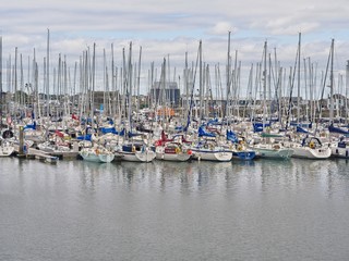 Large amount of sailboats densely packed at the marina of Howth (Ireland) near Dublin on an overcast summer day