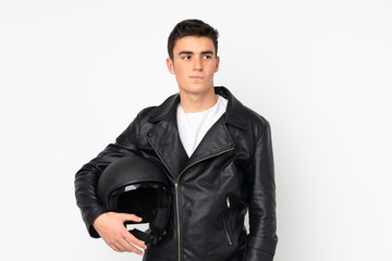 Man holding a motorcycle helmet isolated on white background thinking an idea