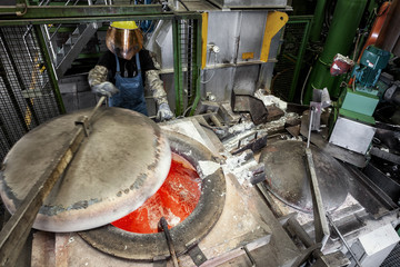 Skilled worker at the aluminum melt preparing the raw material for die casting