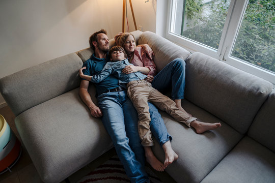Happy family relaxing on couch