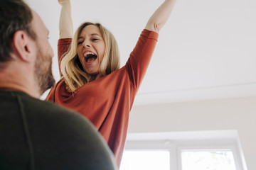 Man lifting and embracing his cheering wife